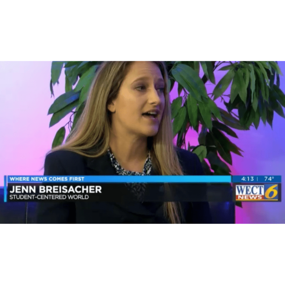 A woman with long hair is speaking during a news interview. Her name and the phrase Student-Centered World are displayed on the screen. The background features a plant and the WECT News 6 logo.