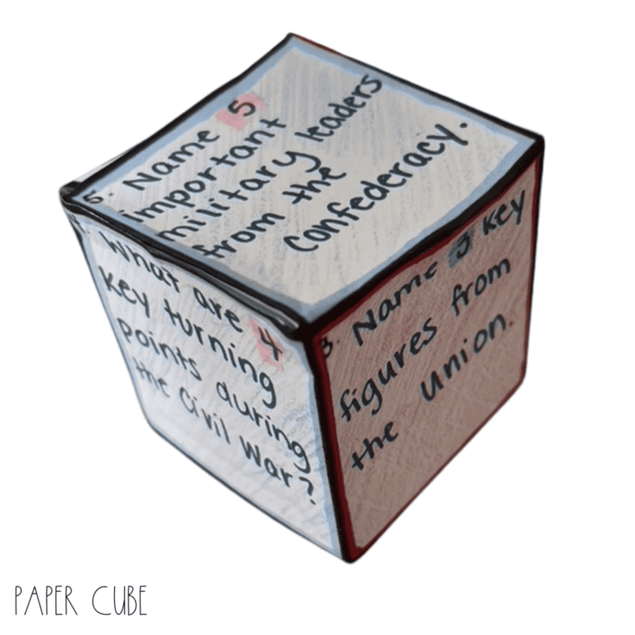 A paper cube with handwritten questions on its faces about the Civil War, including topics like military leaders from the Confederacy and key figures from the Union. The text PAPER CUBE is at the bottom.